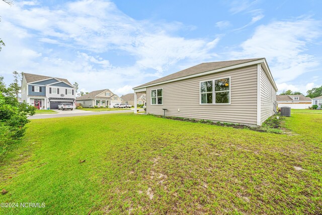 view of yard with a garage and cooling unit