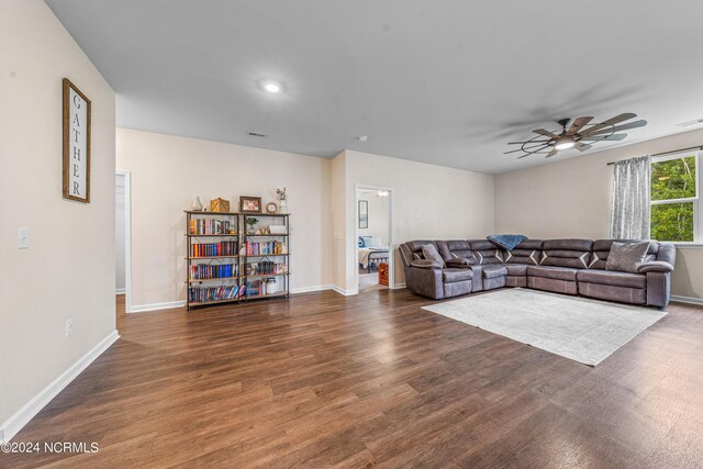 living room with ceiling fan and dark hardwood / wood-style floors