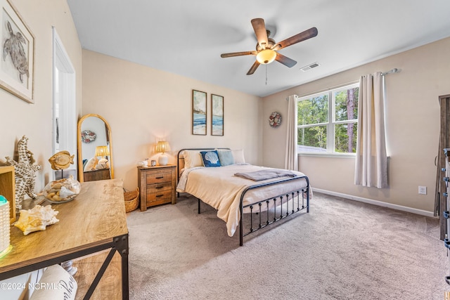 carpeted bedroom featuring visible vents, baseboards, and a ceiling fan