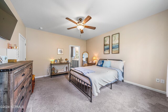 carpeted bedroom with ceiling fan and ensuite bathroom