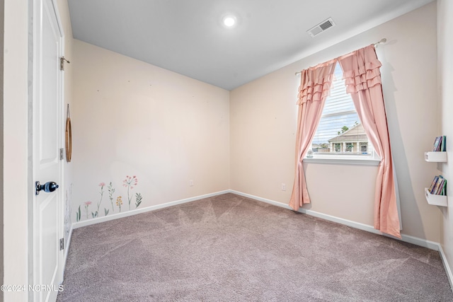 carpeted empty room with visible vents and baseboards