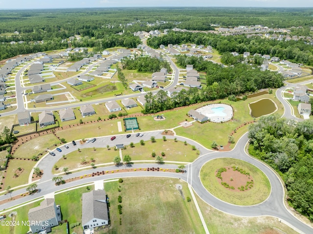 drone / aerial view featuring a residential view and a view of trees