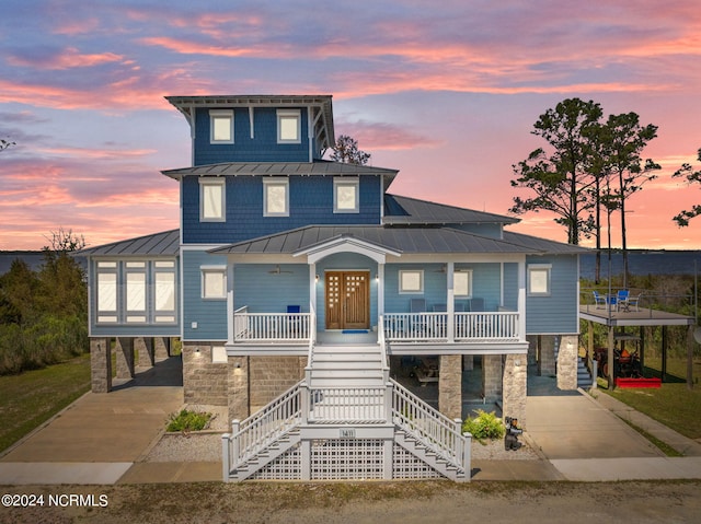 view of front of property with a porch and a carport