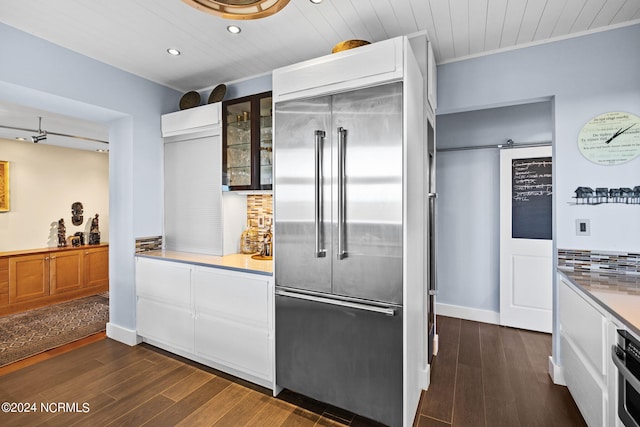 kitchen featuring dark hardwood / wood-style flooring, wooden ceiling, and appliances with stainless steel finishes