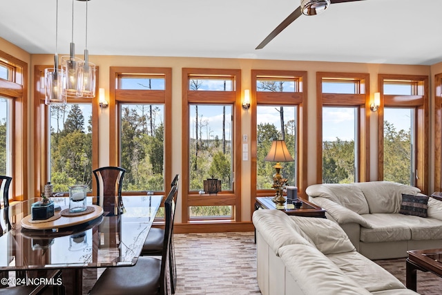 sunroom featuring a notable chandelier and a wealth of natural light