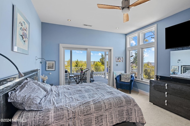 bedroom featuring access to exterior, light colored carpet, and ceiling fan