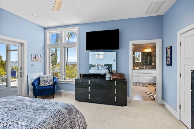 carpeted bedroom featuring access to exterior, connected bathroom, ceiling fan, and sink