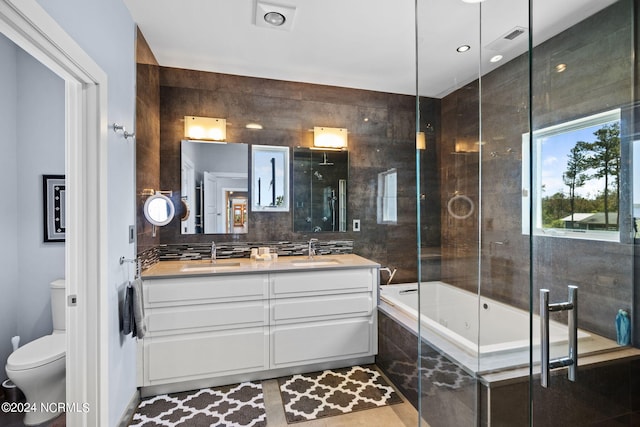 full bathroom featuring vanity, toilet, backsplash, and independent shower and bath