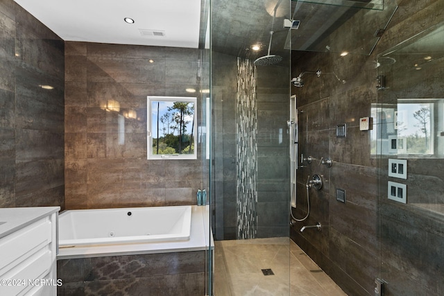 bathroom featuring vanity and shower with separate bathtub