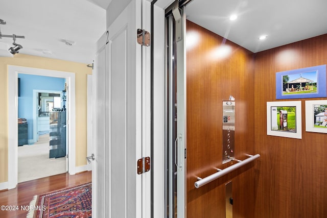 hallway featuring dark hardwood / wood-style floors and elevator