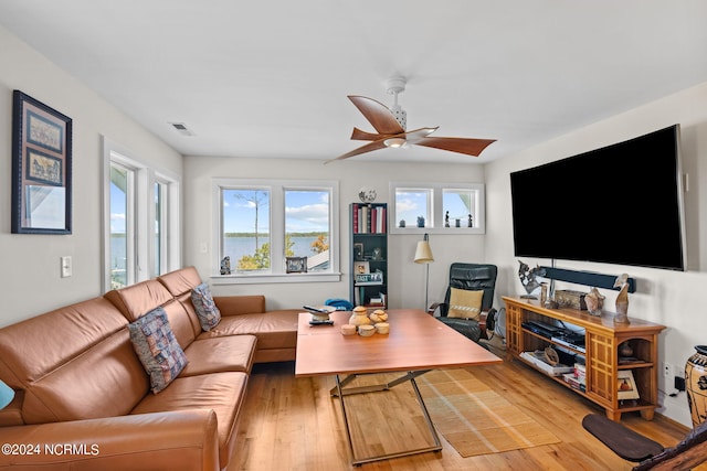 living room with ceiling fan and light hardwood / wood-style floors