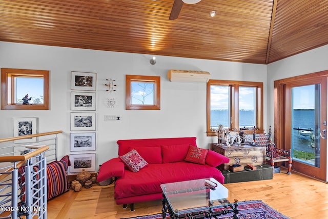 living room with hardwood / wood-style floors, a water view, ceiling fan, a wall mounted AC, and wood ceiling