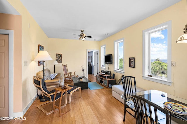 living room with ceiling fan, light hardwood / wood-style flooring, and a healthy amount of sunlight