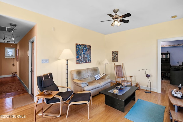 living room with ceiling fan and hardwood / wood-style floors