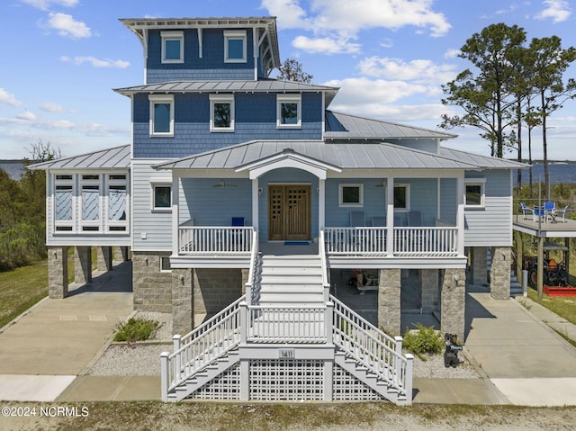 view of front of home featuring a porch, a balcony, and a carport