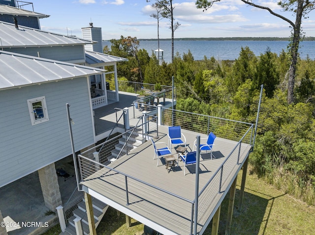 wooden terrace featuring a water view