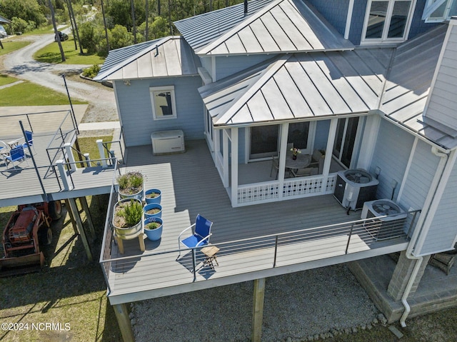 back of property featuring central air condition unit and a wooden deck