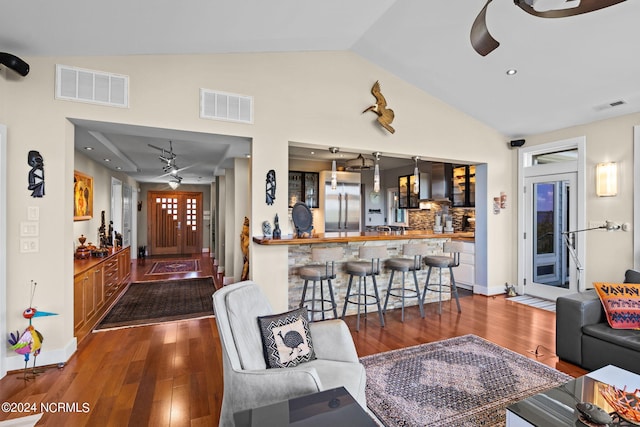 living room featuring dark hardwood / wood-style flooring, vaulted ceiling, ceiling fan, and beverage cooler