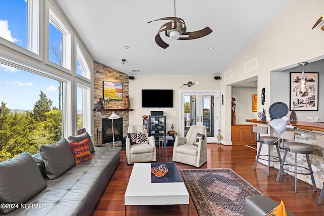 living room with ceiling fan, dark hardwood / wood-style flooring, a fireplace, and french doors