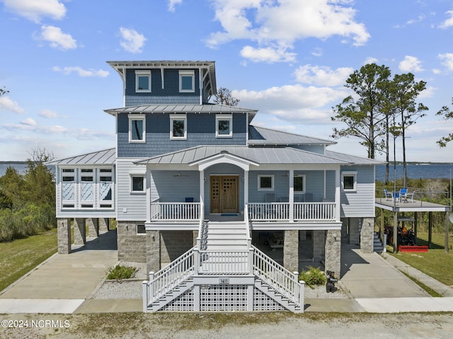 view of front of home with a porch and a carport