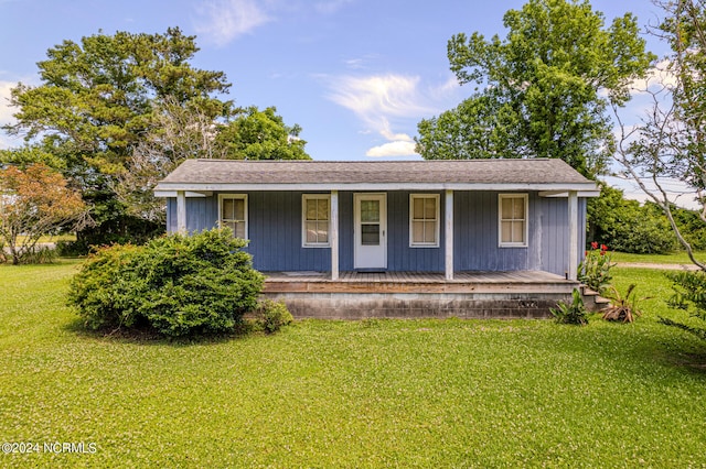 view of front of home with a porch and a front yard