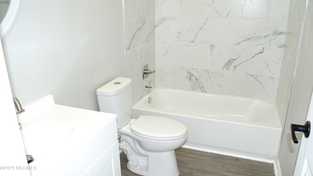 bathroom featuring  shower combination, vanity, toilet, and wood finished floors