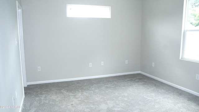 empty room with carpet flooring and baseboards