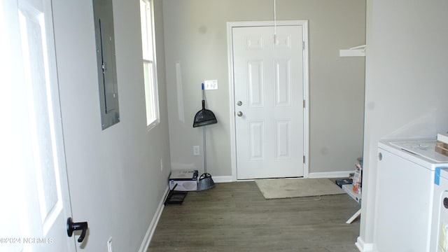 laundry room featuring washer / clothes dryer, wood finished floors, laundry area, electric panel, and baseboards