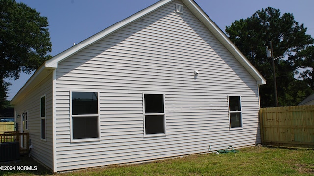 view of home's exterior with a yard, fence, and central AC unit