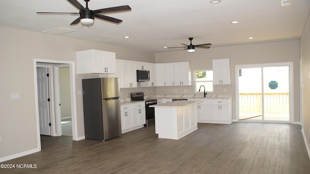 kitchen featuring white cabinets, appliances with stainless steel finishes, and light countertops