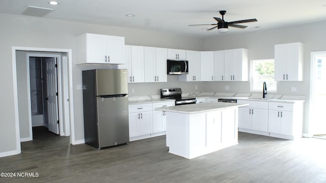 kitchen featuring stainless steel appliances, light countertops, visible vents, white cabinetry, and a sink