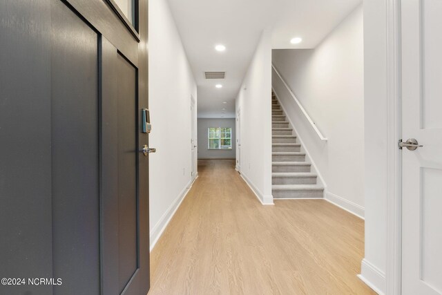 hallway with light hardwood / wood-style floors