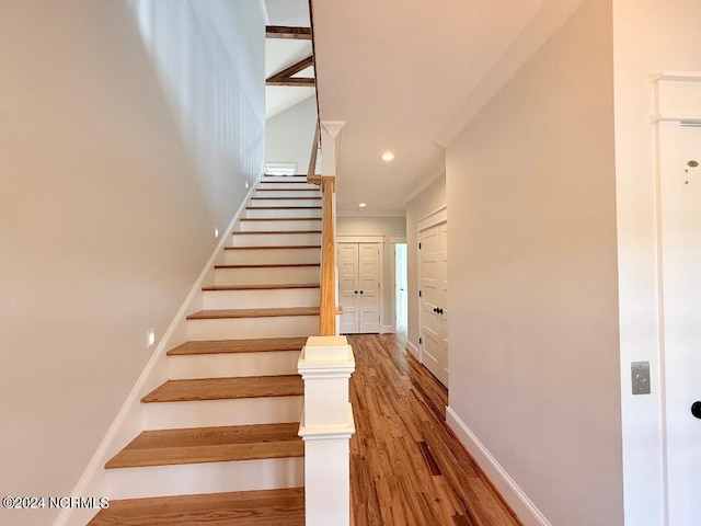 stairs featuring hardwood / wood-style floors