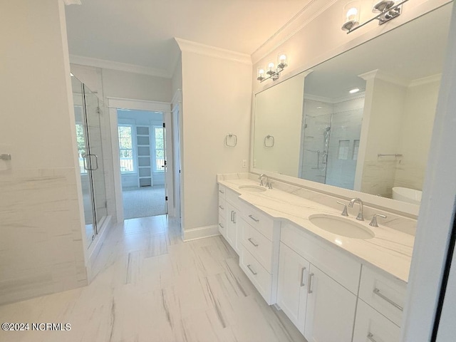 bathroom with vanity, a shower with door, and crown molding