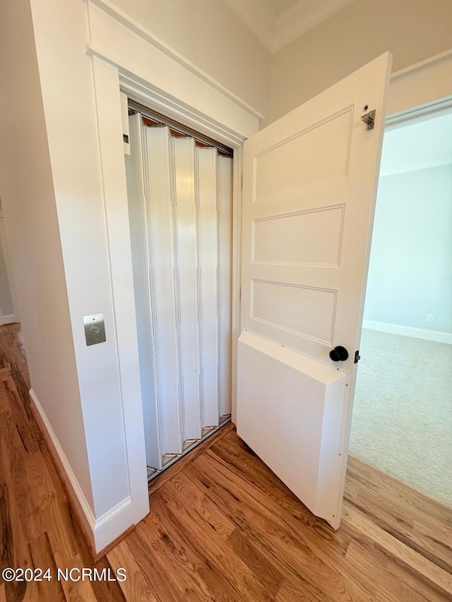 hallway with hardwood / wood-style floors