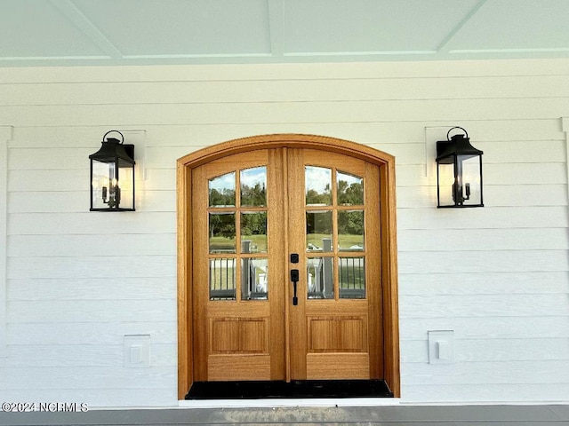 view of exterior entry featuring french doors