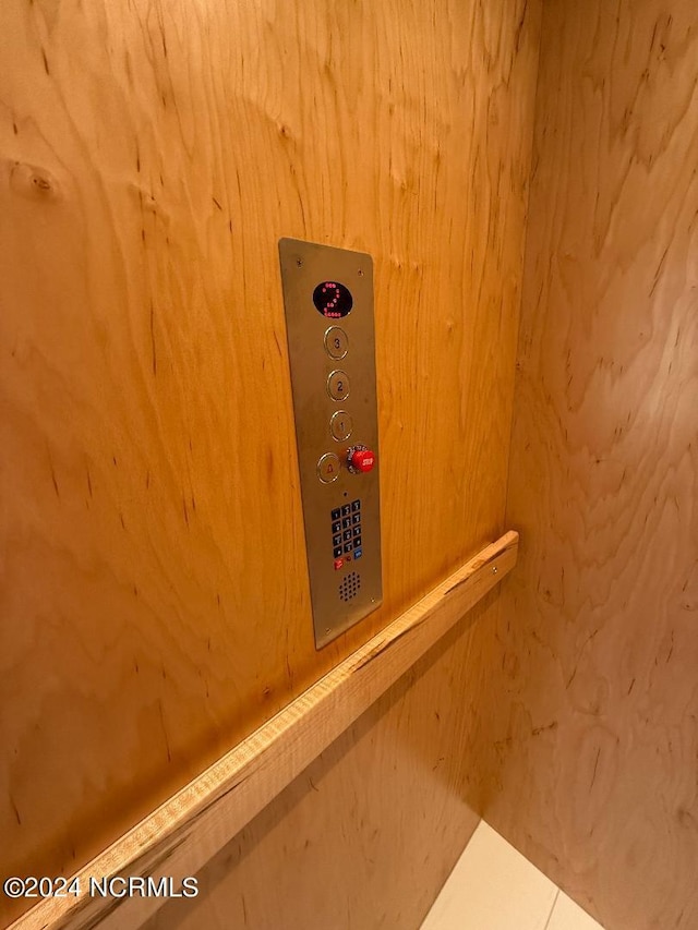 room details featuring elevator and wood walls