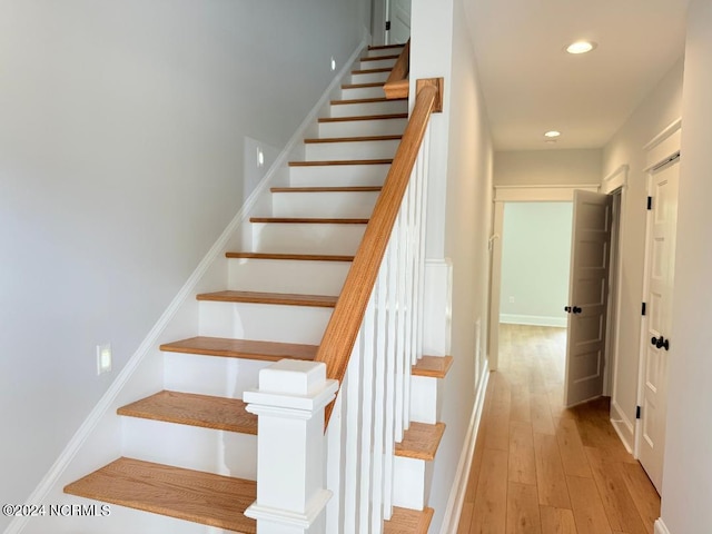 stairs featuring wood-type flooring