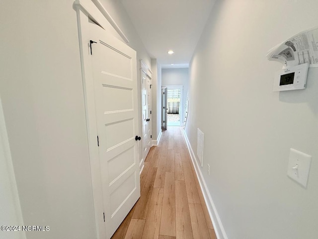 hallway with light wood-type flooring