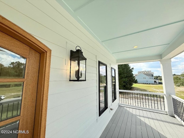 wooden terrace featuring covered porch