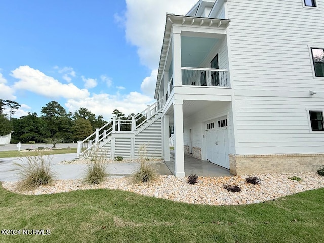 view of home's exterior with a yard and a garage