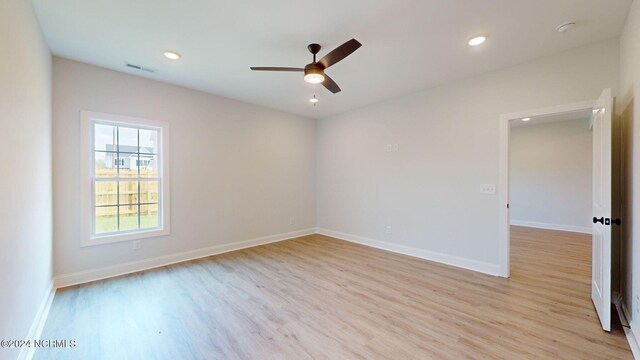 spare room with recessed lighting, visible vents, light wood-style floors, a ceiling fan, and baseboards