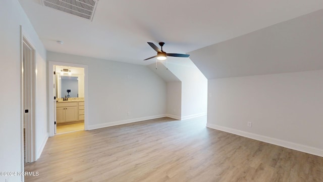 additional living space with ceiling fan, light wood finished floors, visible vents, and baseboards