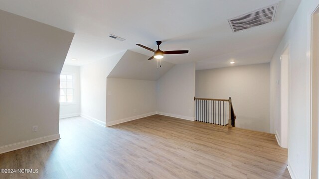 bonus room featuring baseboards, visible vents, a ceiling fan, lofted ceiling, and wood finished floors