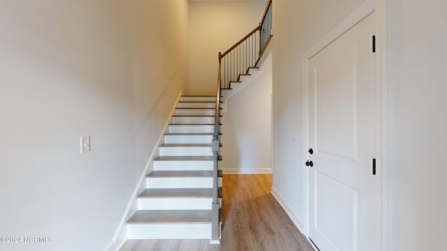 stairs with baseboards and wood finished floors