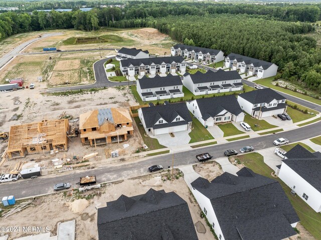 drone / aerial view with a residential view and a wooded view