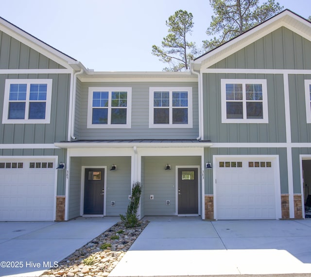 383 James St, Vass, NC 28394 - view of front facade with concrete driveway, an attached garage, board and batten siding, and stone siding