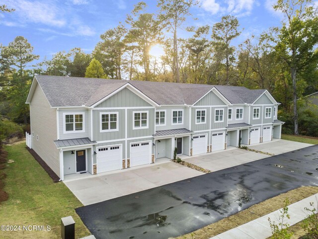 383 James St, Vass, NC 28394 - multi unit property featuring an attached garage, roof with shingles, metal roof, driveway, and a standing seam roof
