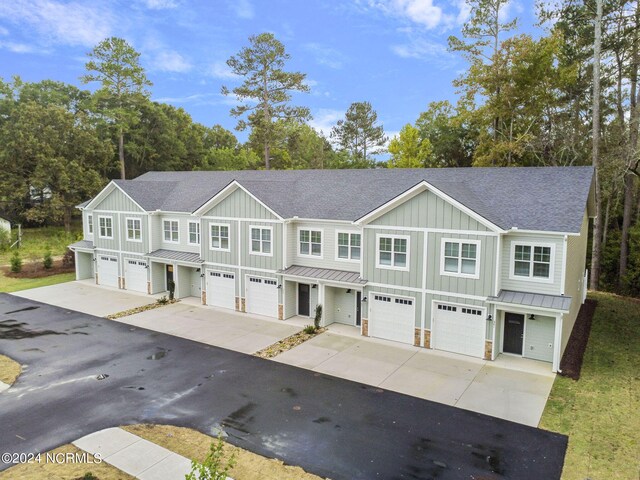 383 James St, Vass, NC 28394 - townhome / multi-family property featuring a standing seam roof, concrete driveway, and a garage