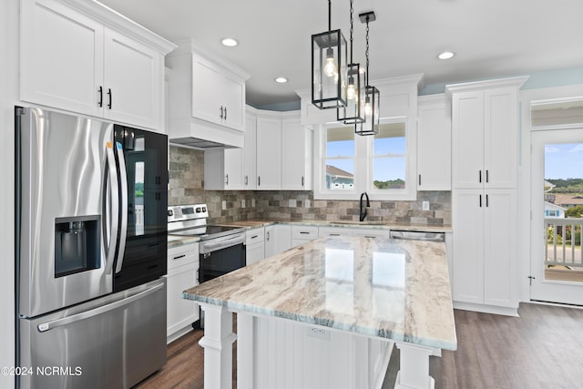 kitchen featuring a center island, dark hardwood / wood-style floors, white cabinets, sink, and appliances with stainless steel finishes